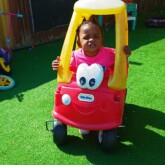 child playing in car